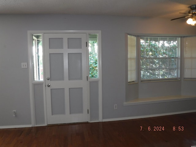 entrance foyer featuring ceiling fan, dark wood-style flooring, and baseboards