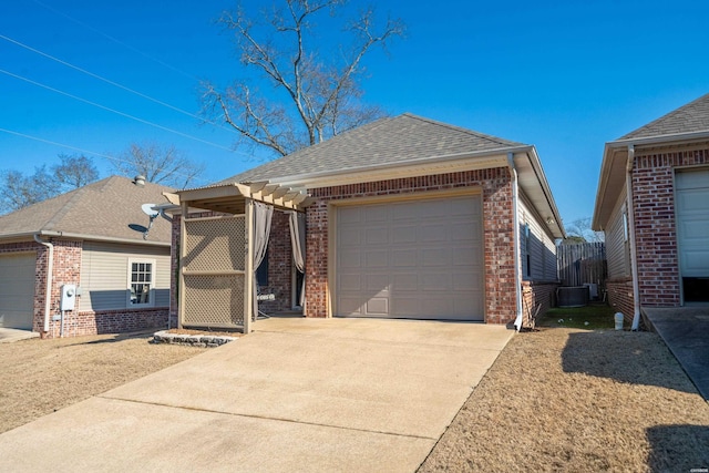 ranch-style house featuring a garage, brick siding, driveway, and a shingled roof