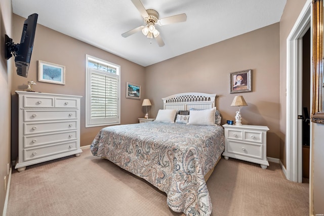 bedroom with baseboards, a ceiling fan, and light carpet