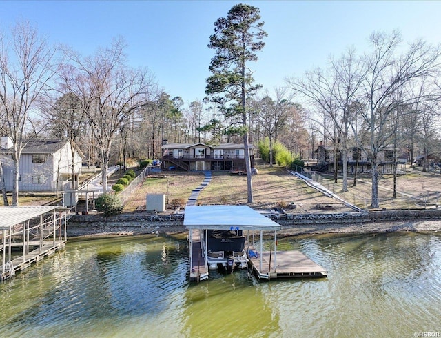 view of dock with boat lift, stairs, and a deck with water view