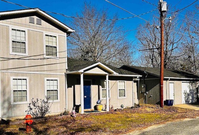 view of front of house with a shingled roof and a garage