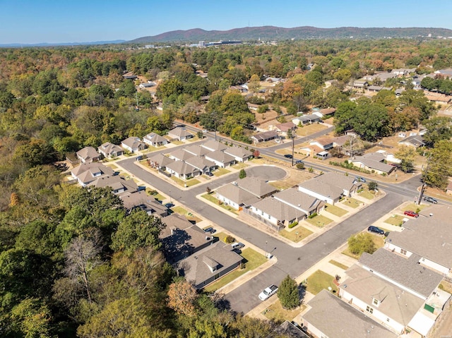 aerial view featuring a mountain view, a wooded view, and a residential view