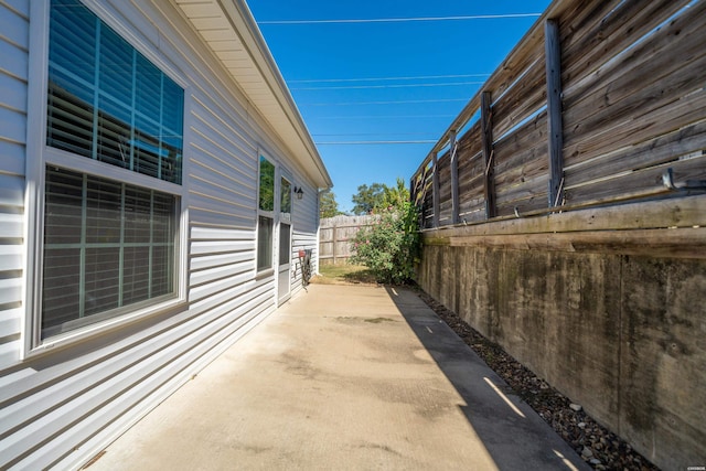 view of property exterior featuring a patio area and a fenced backyard