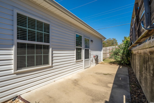 view of side of property with a fenced backyard and a patio