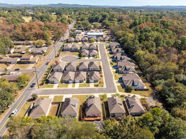 drone / aerial view with a residential view and a view of trees