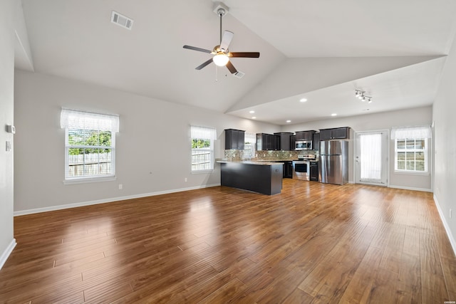 kitchen with visible vents, appliances with stainless steel finishes, open floor plan, a peninsula, and light countertops