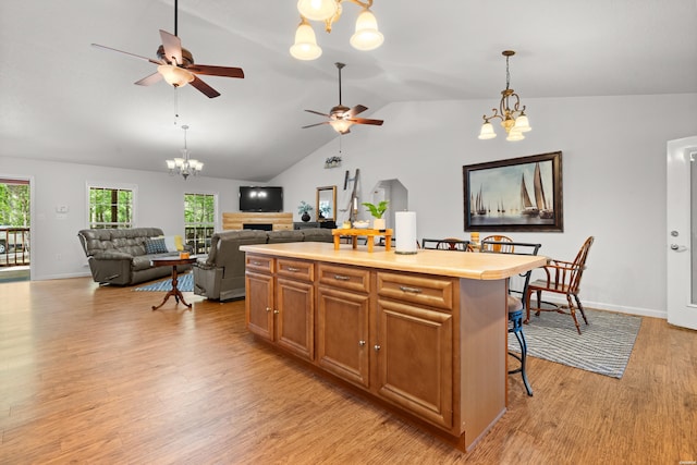 67 Delton Mccauley Rd, Kirby, AR 71950 - kitchen featuring a chandelier, light wood-style flooring, a ceiling fan, lofted ceiling, and decorative light fixtures