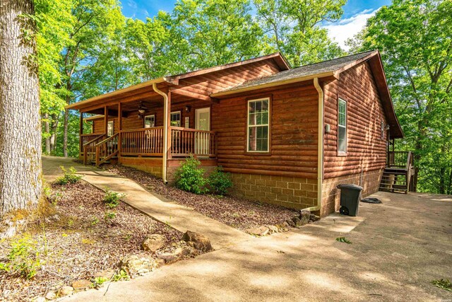 67 Delton Mccauley Rd, Kirby, AR 71950 - rustic home featuring covered porch, a ceiling fan, and log veneer siding