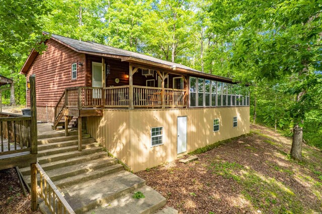 67 Delton Mccauley Rd, Kirby, AR 71950 - view of front of house featuring faux log siding, stairway, and a deck
