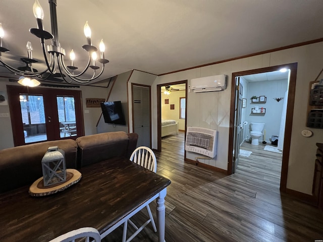 dining space featuring french doors, dark wood-style floors, heating unit, crown molding, and an AC wall unit