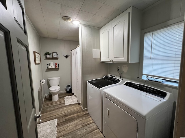 laundry area with dark wood-style floors, laundry area, washer and clothes dryer, and baseboards