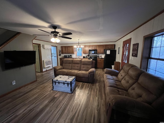 living room with ceiling fan with notable chandelier, dark wood-type flooring, and crown molding