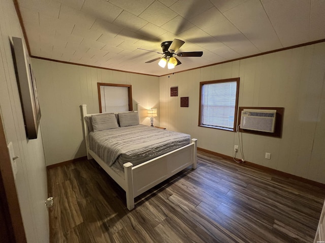 bedroom with dark wood-type flooring, a ceiling fan, baseboards, an AC wall unit, and crown molding