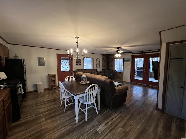 dining room featuring a wood stove, ornamental molding, dark wood-type flooring, and french doors