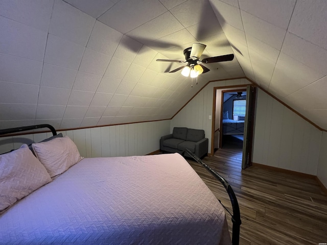 bedroom with ceiling fan, vaulted ceiling, and wood finished floors