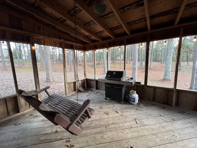 unfurnished sunroom featuring lofted ceiling