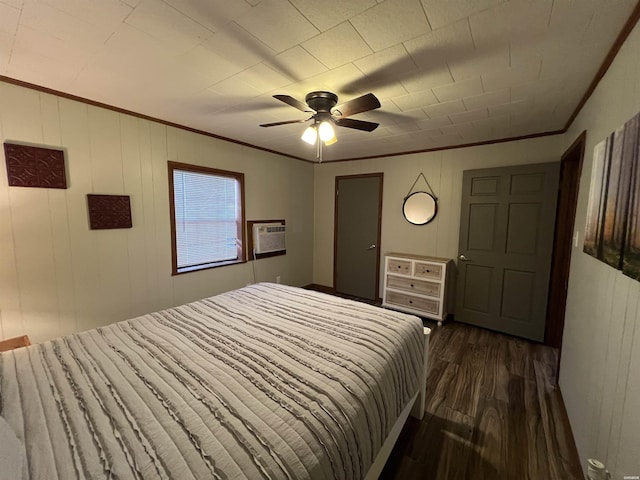 bedroom with dark wood-style flooring, crown molding, a wall mounted AC, and ceiling fan