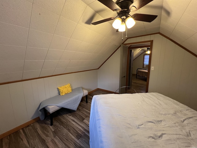 bedroom with lofted ceiling, baseboards, a ceiling fan, and dark wood-style flooring