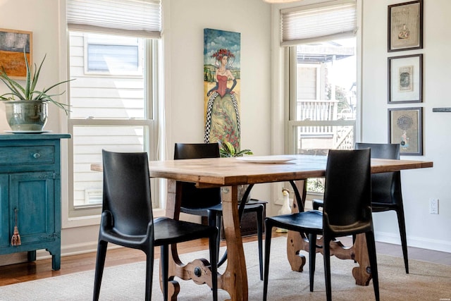 dining room featuring baseboards and light wood-style flooring
