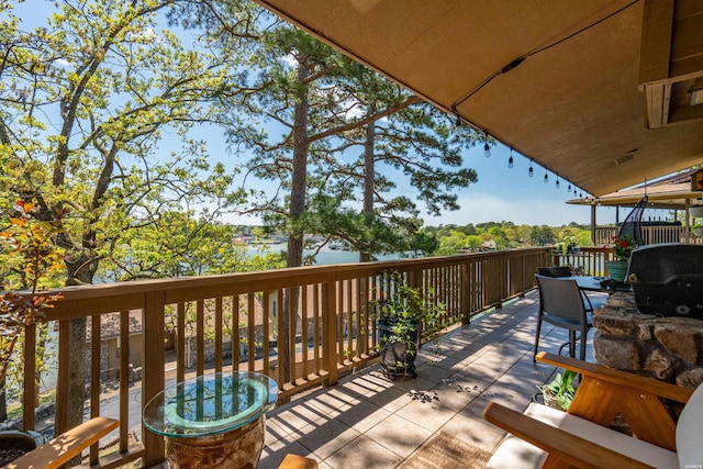 wooden deck with a grill