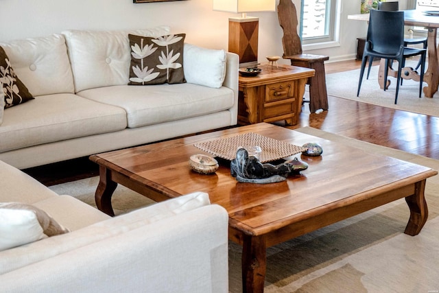 living room with baseboards and wood finished floors