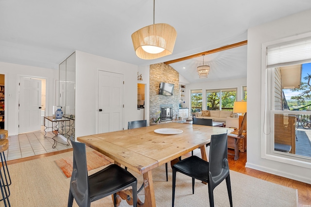 dining area with lofted ceiling with beams and wood finished floors