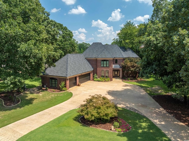 view of front of house with concrete driveway, brick siding, an attached garage, and a front lawn