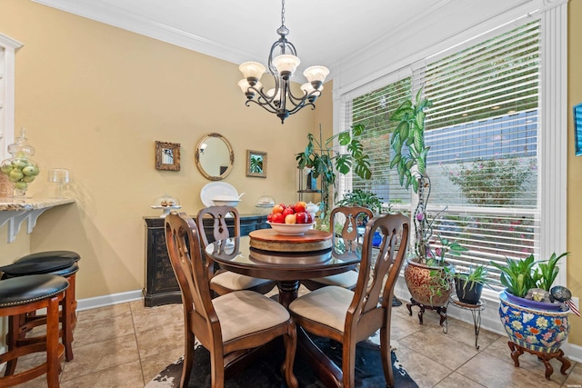 dining room featuring light tile patterned flooring, crown molding, baseboards, and an inviting chandelier