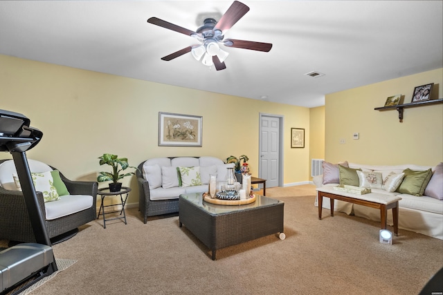 living area with light carpet, ceiling fan, visible vents, and baseboards