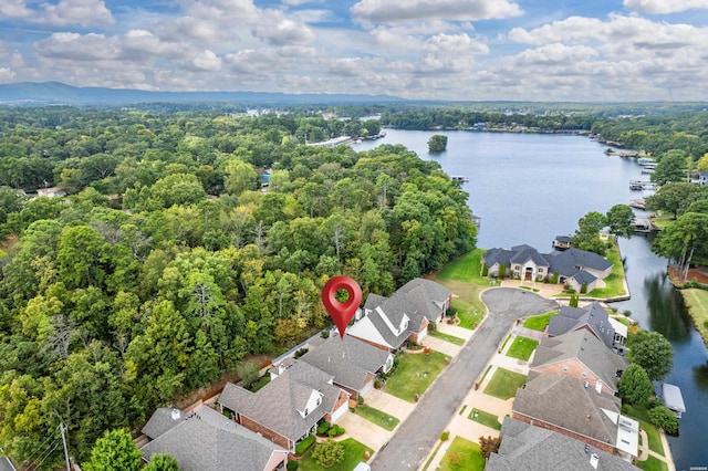 birds eye view of property featuring a water view, a forest view, and a residential view