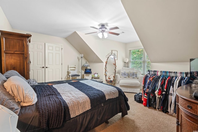 bedroom featuring lofted ceiling, visible vents, carpet flooring, and a ceiling fan