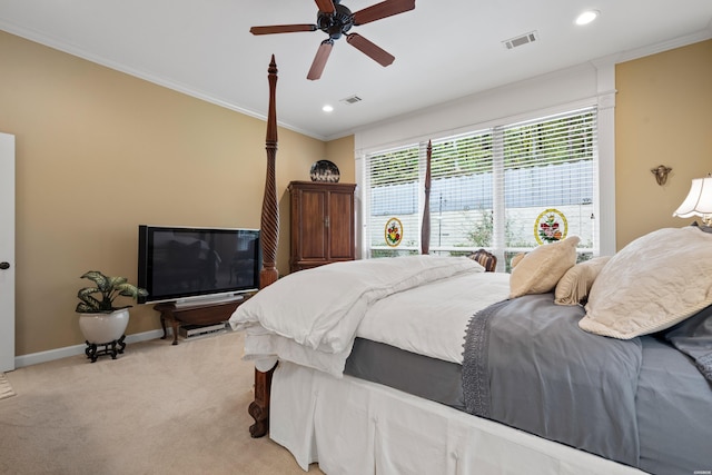 bedroom featuring baseboards, visible vents, light colored carpet, ceiling fan, and crown molding