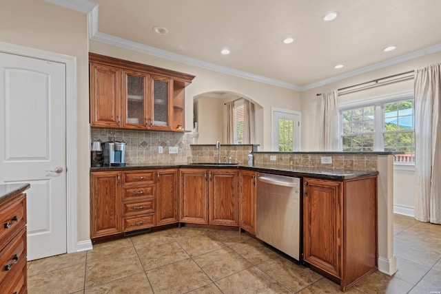 140 Frontier Trl, Hot Springs, AR 71913 - kitchen with stainless steel dishwasher, a sink, arched walkways, brown cabinets, and ornamental molding