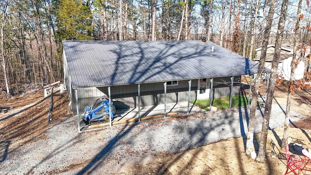 exterior space with metal roof and driveway