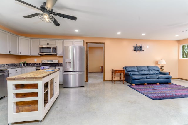 120 Needham Rd, Fountain Lake, AR 71901 - kitchen featuring butcher block countertops, open floor plan, finished concrete flooring, ceiling fan, and appliances with stainless steel finishes