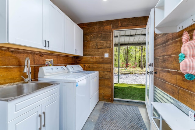 120 Needham Rd, Fountain Lake, AR 71901 - clothes washing area with a sink, wood walls, washing machine and clothes dryer, and cabinet space