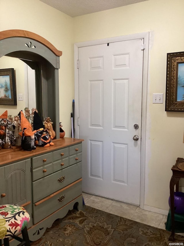 doorway featuring a textured ceiling