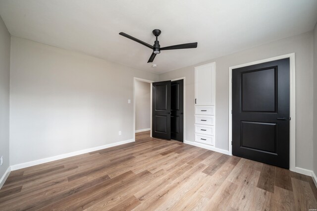 unfurnished bedroom featuring light wood finished floors, baseboards, and a ceiling fan