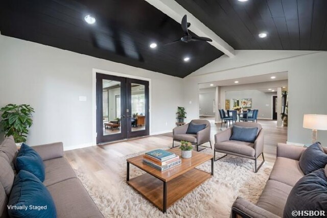 living area featuring vaulted ceiling with beams, recessed lighting, a ceiling fan, french doors, and light wood-type flooring