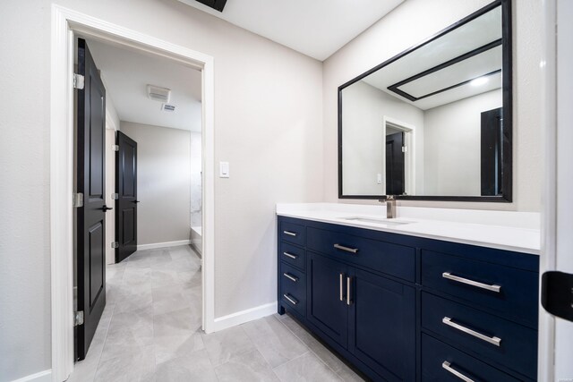 full bathroom with baseboards, tub / shower combination, and vanity