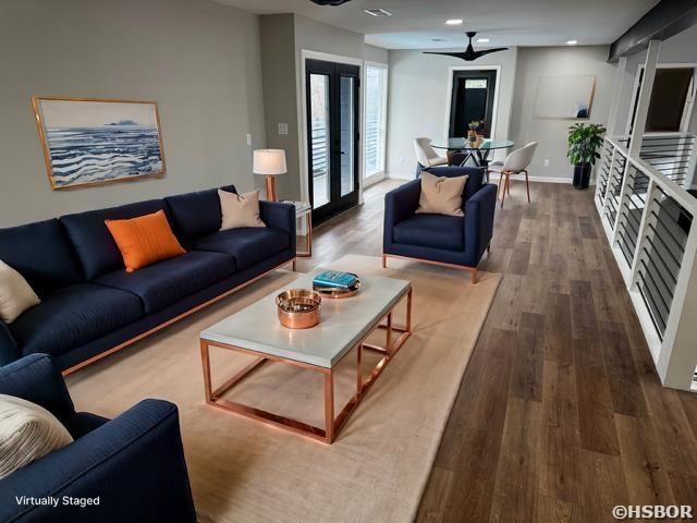 living room featuring recessed lighting, french doors, baseboards, and wood finished floors