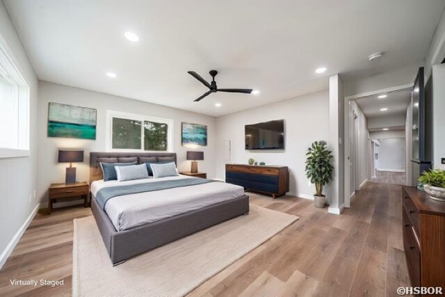 bedroom with baseboards, wood finished floors, and recessed lighting