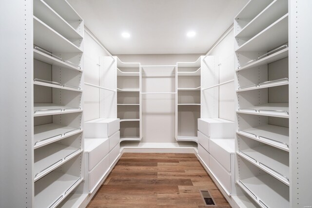 walk in closet with dark wood-type flooring and visible vents