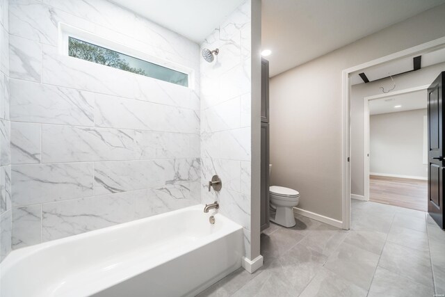 full bath with baseboards, shower / bathing tub combination, and toilet