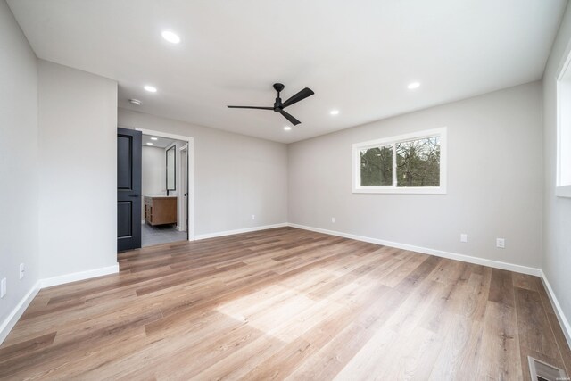 unfurnished room featuring light wood-type flooring, baseboards, visible vents, and recessed lighting