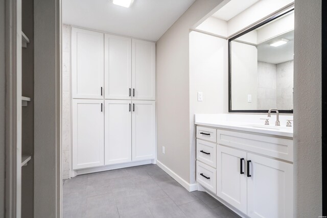 full bathroom featuring vanity and baseboards