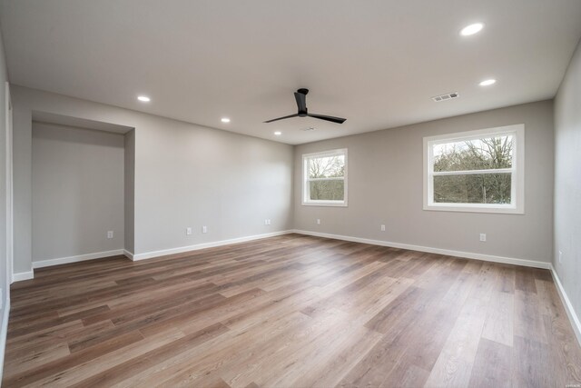 spare room featuring recessed lighting, visible vents, baseboards, and wood finished floors