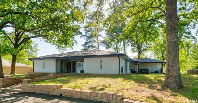 rear view of property featuring a yard