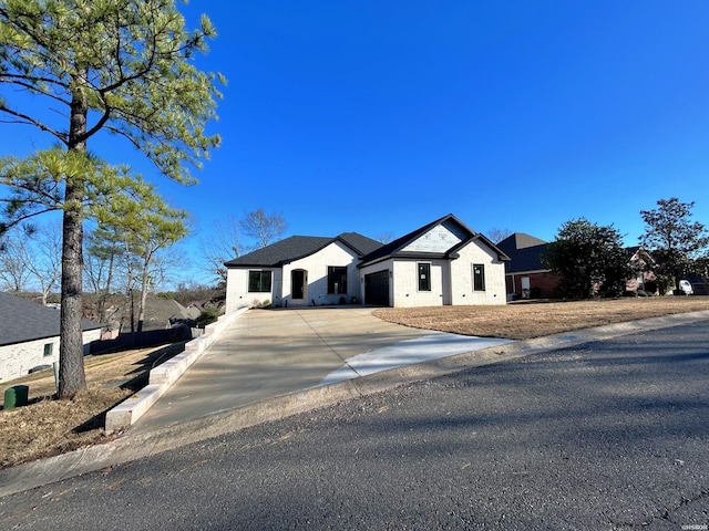 modern farmhouse featuring a residential view and concrete driveway