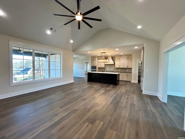 unfurnished living room featuring dark wood-type flooring, recessed lighting, ceiling fan, and baseboards